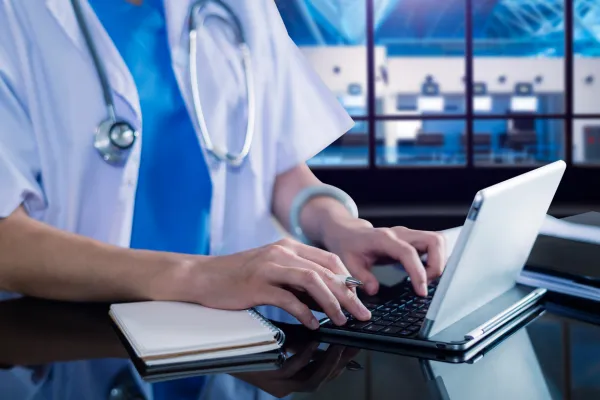 Doctor typing on keyboard