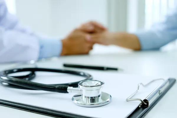 Doctor holding patient's hand