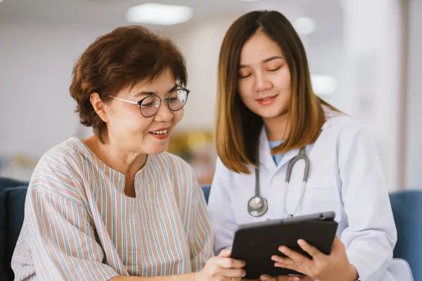 Doctor showing patient something on tablet